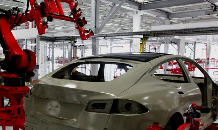 Cars being manufactured inside of a cleanroom automotive facility