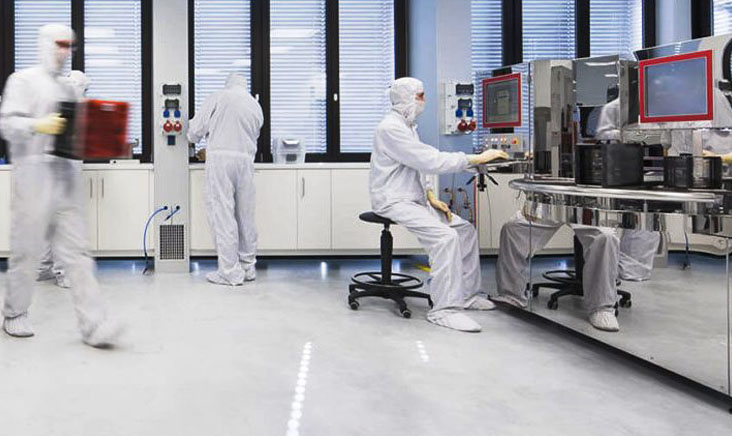 Workers working inside of a cleanroom environment