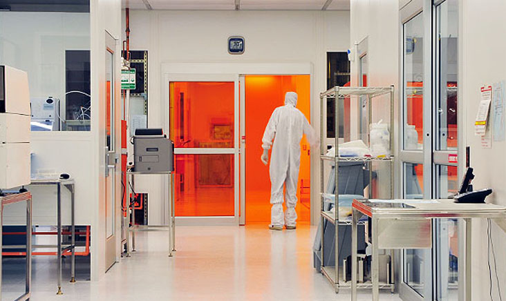 Man in white hazad suit carrying out cleanroom testing