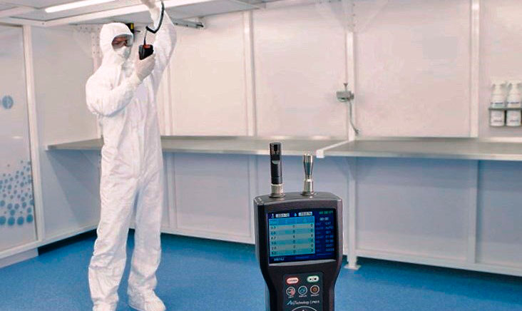 Man in cleanroom testing environment wearing white hazmat suit