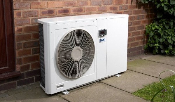 Air source heat pump stood outside house